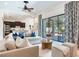 Comfortable living room featuring a ceiling fan and seamless indoor-outdoor transition to the patio at 13008 Eagles Entry Dr, Odessa, FL 33556