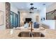 Spacious living room featuring stylish decor and a view of the kitchen and backyard at 13008 Eagles Entry Dr, Odessa, FL 33556