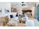 Open-concept living room boasts a comfortable sofa, view to dining room, and staircase with iron railings at 13008 Eagles Entry Dr, Odessa, FL 33556