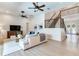 Bright living room features a staircase with elegant iron railings and an entrance to the foyer at 13008 Eagles Entry Dr, Odessa, FL 33556