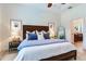 Bright main bedroom featuring modern decor, a plush bed, and an ensuite bathroom at 13008 Eagles Entry Dr, Odessa, FL 33556