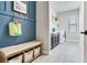 A mud room with a bench, storage, and adjacent laundry room at 13008 Eagles Entry Dr, Odessa, FL 33556