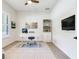 Bright office space features wood floors, a ceiling fan, and modern desk next to built-in bookcase at 13008 Eagles Entry Dr, Odessa, FL 33556