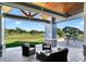 Inviting outdoor seating area with comfortable chairs and a stunning view of the lush golf course at 13008 Eagles Entry Dr, Odessa, FL 33556