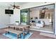 A covered patio with a dining table flows into an open-concept living area with neutral decor at 13008 Eagles Entry Dr, Odessa, FL 33556