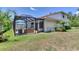 Inviting screened-in pool with outdoor seating and lush landscaping creates a private backyard oasis at 13008 Eagles Entry Dr, Odessa, FL 33556