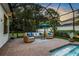 Serene screened-in pool area with comfortable outdoor seating and lush landscaping at 13008 Eagles Entry Dr, Odessa, FL 33556
