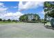 Community tennis court surrounded by mature trees, perfect for outdoor recreation and exercise at 13008 Eagles Entry Dr, Odessa, FL 33556