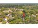 An aerial view of a house surrounded by green trees in a serene, residential neighborhood at 1308 W Perdiz St, Tampa, FL 33612