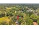 An aerial view of a house nestled among mature trees in a quiet residential neighborhood at 1308 W Perdiz St, Tampa, FL 33612