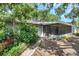 Backyard home exterior with landscaping leading to screened in porch at 1308 W Perdiz St, Tampa, FL 33612