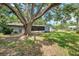 Spacious backyard featuring large tree and swing set at 1308 W Perdiz St, Tampa, FL 33612