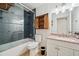 Stylish bathroom featuring a blue tiled shower and a vanity with ample storage at 1308 W Perdiz St, Tampa, FL 33612