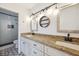 Bathroom featuring double vanity, granite countertops, new lighting, and tiled walk-in shower at 1308 W Perdiz St, Tampa, FL 33612