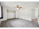 Bright bedroom with ceiling fan, neutral walls, and a closet with a view into the hallway at 1308 W Perdiz St, Tampa, FL 33612