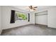 Spacious bedroom with neutral walls, ceiling fan, closet, and ample natural light from the large window at 1308 W Perdiz St, Tampa, FL 33612