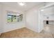 Bright bonus room features neutral paint, tile floor, and a large window offering relaxing backyard views at 1308 W Perdiz St, Tampa, FL 33612