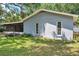 Side and rear exterior of home showcasing lawn with shaded areas at 1308 W Perdiz St, Tampa, FL 33612