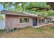 Single-Gathering home with a well-manicured lawn, beautiful landscaping, and a brick exterior at 1308 W Perdiz St, Tampa, FL 33612