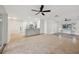 Open-concept living room and kitchen area with tile floors, ceiling fans and access to other rooms at 1308 W Perdiz St, Tampa, FL 33612