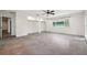 Main bedroom featuring concrete floors, walk in closets, and a ceiling fan at 1308 W Perdiz St, Tampa, FL 33612