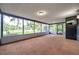 Spacious screened-in porch with neutral carpet and views of the backyard at 1308 W Perdiz St, Tampa, FL 33612