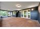 Spacious screened-in porch with neutral carpet, and access to the backyard and patio at 1308 W Perdiz St, Tampa, FL 33612