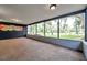 Spacious screened-in porch with view of the backyard, adjacent to a unique art piece at 1308 W Perdiz St, Tampa, FL 33612