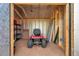 Organized shed interior with lawnmower, shelving and ladder at 1308 W Perdiz St, Tampa, FL 33612