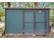 Exterior of backyard shed with brown trim and teal siding at 1308 W Perdiz St, Tampa, FL 33612