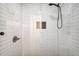 Modern shower with white subway tile, bronze fixtures, and a glass door at 1308 W Perdiz St, Tampa, FL 33612