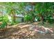 Expansive backyard with a patio area, mature trees and landscaping, ideal for outdoor activities at 1424 Castleworks Ln, Tarpon Springs, FL 34689