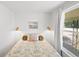 Comfortable bedroom with natural light, terracotta tile flooring, and vintage-style accents at 1424 Castleworks Ln, Tarpon Springs, FL 34689