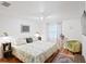 Spacious bedroom featuring a king bed, vintage decor, and terracotta flooring with accent rug at 1424 Castleworks Ln, Tarpon Springs, FL 34689