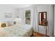 Bright bedroom with terracotta floors offers a view of the backyard through a large window at 1424 Castleworks Ln, Tarpon Springs, FL 34689