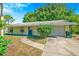 Charming single-story home featuring a well-maintained lawn and a one-car garage at 1424 Castleworks Ln, Tarpon Springs, FL 34689