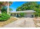 Charming single-story home featuring a well-maintained lawn and a one-car garage at 1424 Castleworks Ln, Tarpon Springs, FL 34689