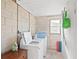 Functional laundry room with washer, dryer, and useful storage, perfect for everyday convenience at 1424 Castleworks Ln, Tarpon Springs, FL 34689