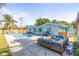 Spacious backyard featuring a refreshing pool, cozy fire pit area, and ample space for outdoor activities and relaxation at 1596 Idle Dr, Clearwater, FL 33756