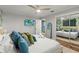 Comfortable bedroom features a leafy accent wall and modern furnishings at 1596 Idle Dr, Clearwater, FL 33756