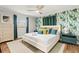 The bedroom has bright, tropical wallpaper and a ceiling fan at 1596 Idle Dr, Clearwater, FL 33756