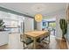 Open dining area with a wooden table and chairs, flowing into the modern kitchen at 1596 Idle Dr, Clearwater, FL 33756
