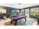 A modern game room with a pool table and outdoor access at 1596 Idle Dr, Clearwater, FL 33756