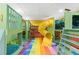 Playroom featuring custom bunkbeds with a slide, climbing wall, and colorful flooring at 1596 Idle Dr, Clearwater, FL 33756