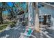 Spacious back deck with outdoor seating, overlooking the lake and lush landscaping at 16019 Chastain Rd, Odessa, FL 33556