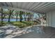 Covered back porch with scenic lake views, accessed by stairs and featuring wood flooring at 16019 Chastain Rd, Odessa, FL 33556