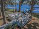 Lakefront home with backyard patio, walkway to pier, fire pit, built-in seating and waterfront views at 16019 Chastain Rd, Odessa, FL 33556