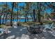 Relax on the patio with lake views and mature trees, and a seating area with an umbrella at 16019 Chastain Rd, Odessa, FL 33556