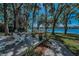 Enjoy lake views from the backyard deck with Adirondack chairs and lush landscaping at 16019 Chastain Rd, Odessa, FL 33556