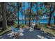 Stunning backyard with a deck that overlooks a pristine lake, perfect for relaxing and enjoying the serene water views at 16019 Chastain Rd, Odessa, FL 33556